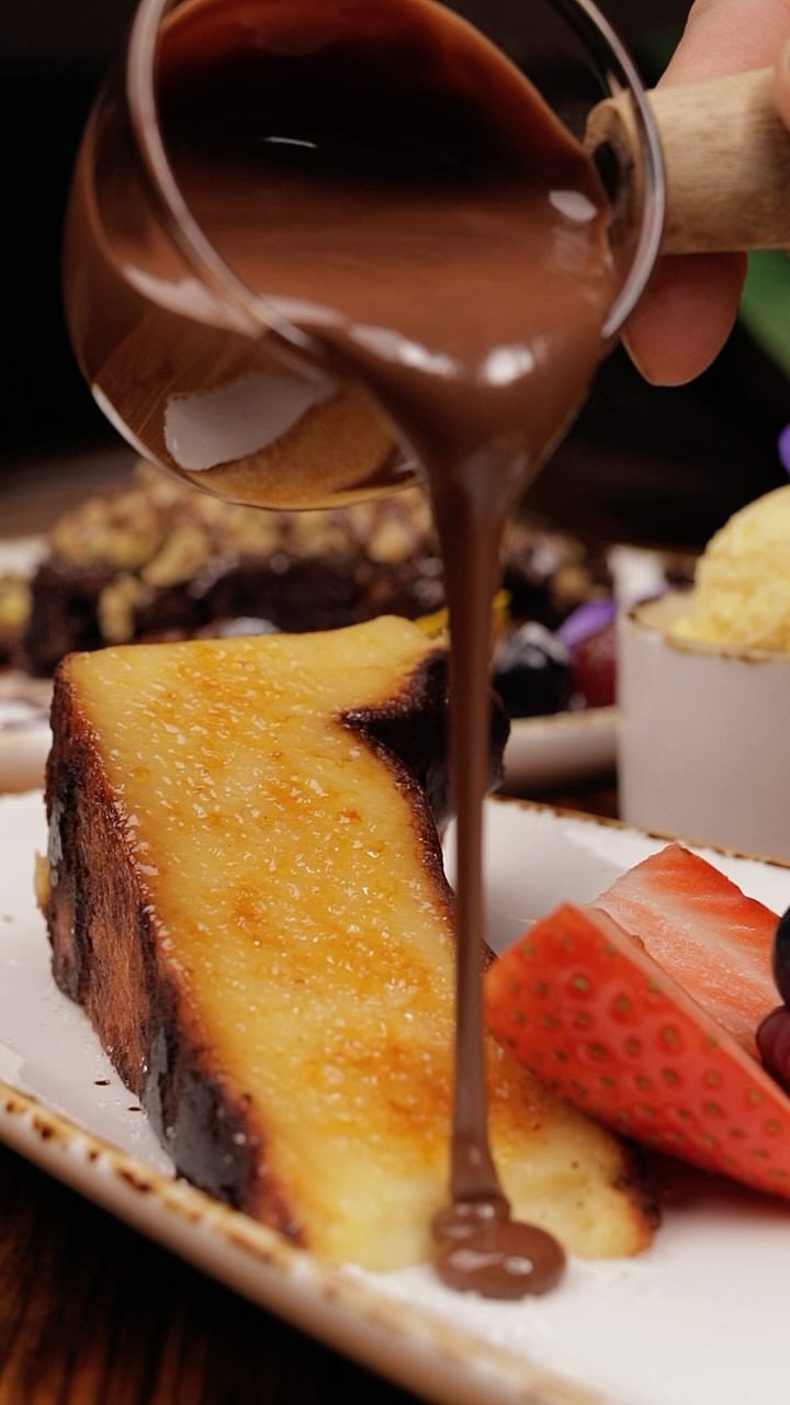 Warm chocolate poured over dessert