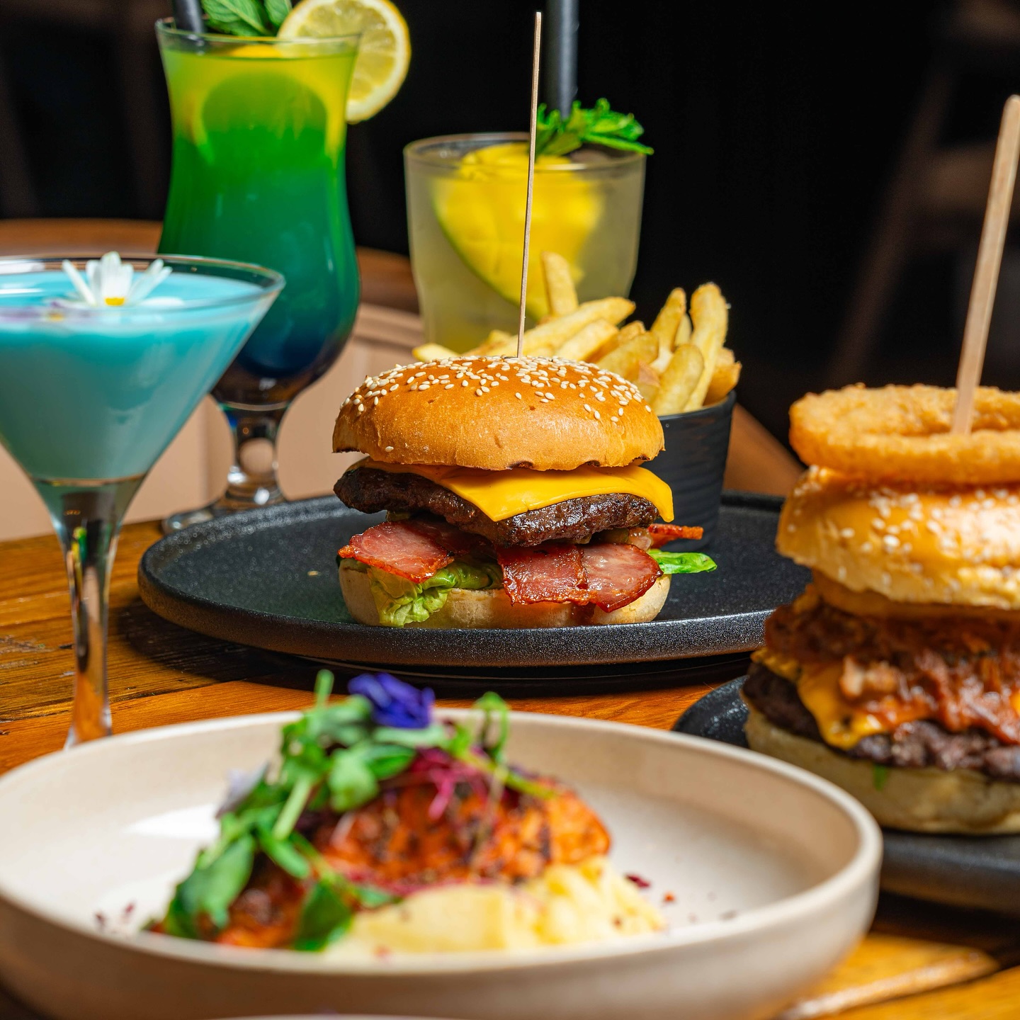 Stacked burger with blue lagoon mocktail
